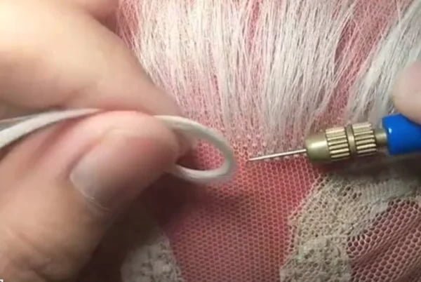 Custom Wig Making Process A detailed view of a wig being hand-tied