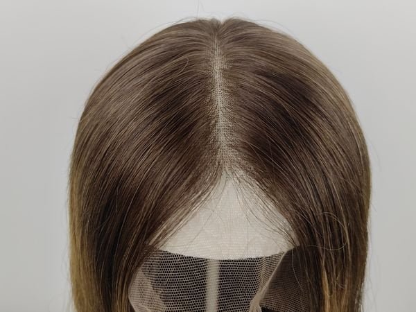 Wig Cap Construction Quality A detailed view of a lace top wig's cap construction, showing the hand-tied knots and the lace material.