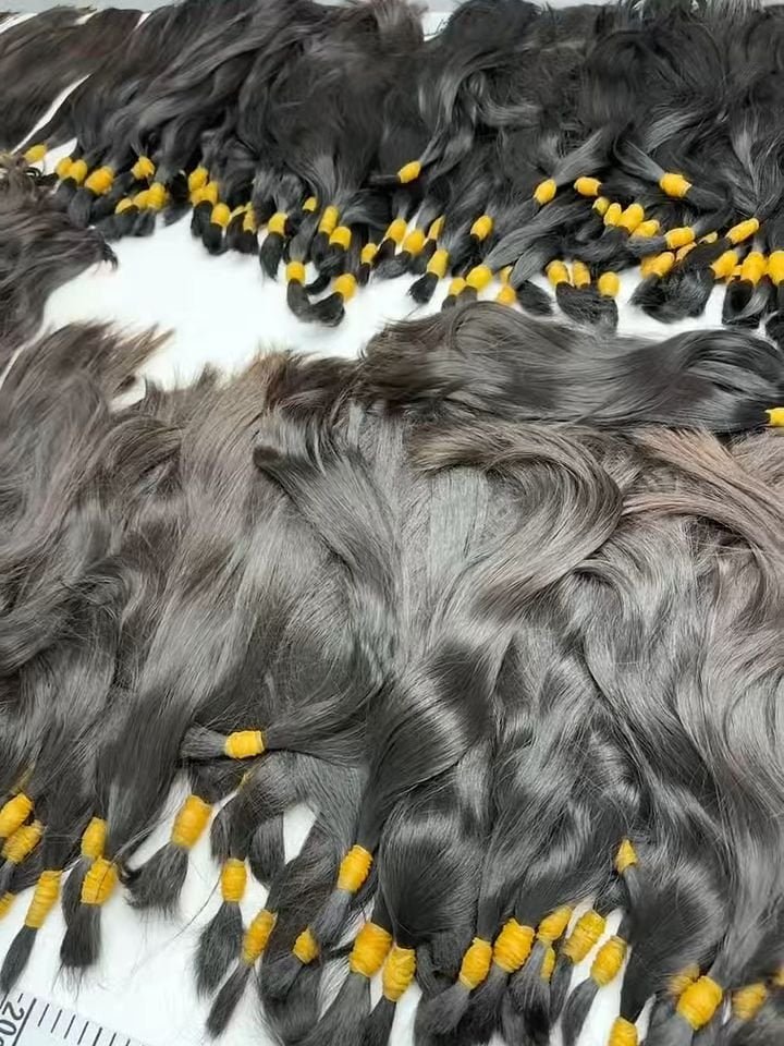 Bundles of raw human hair sorted by length and color